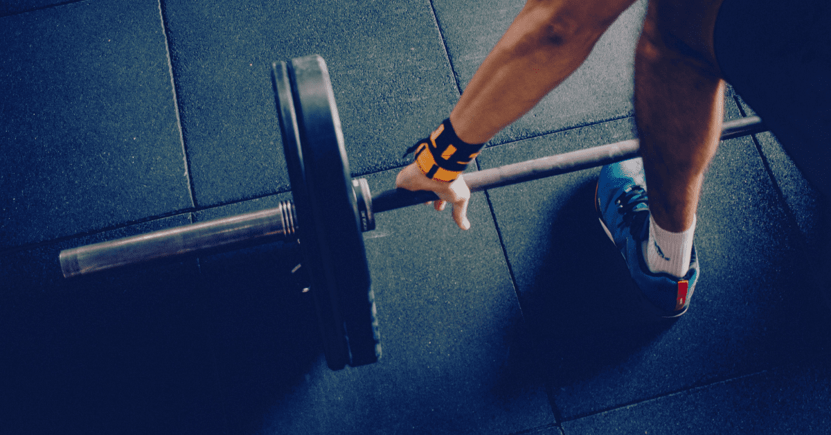 Man lifting weights in dumbbells in the gym to change his body