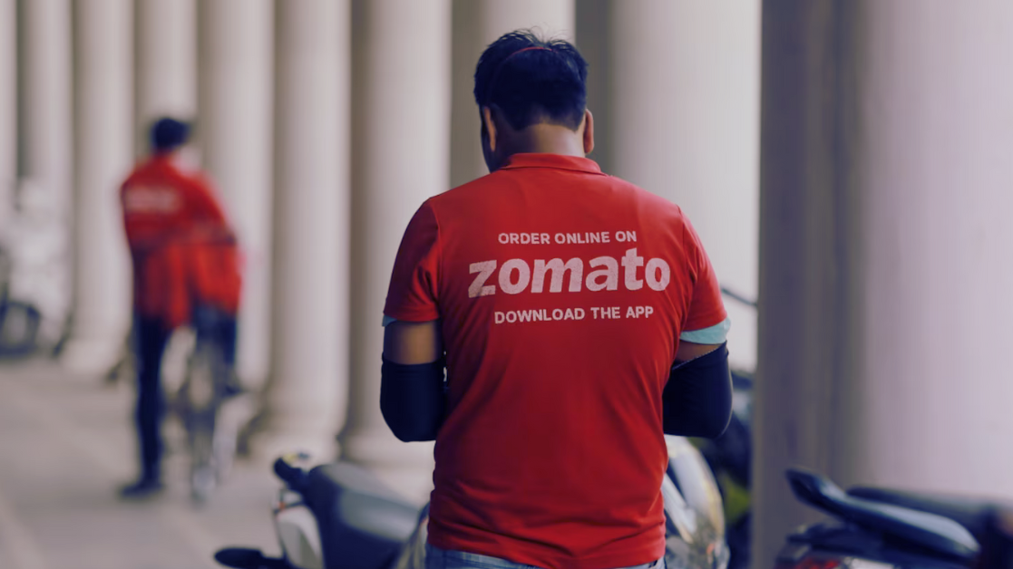 An Zomato delivery man wearing the Zomato t-shirt. It promotes the Zomato business model by how they succeed in food industry.